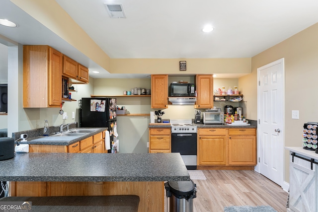 1436 Virginia Way, Monroe, GA 30655 - kitchen featuring black appliances, open shelves, a peninsula, under cabinet range hood, and light wood-type flooring
