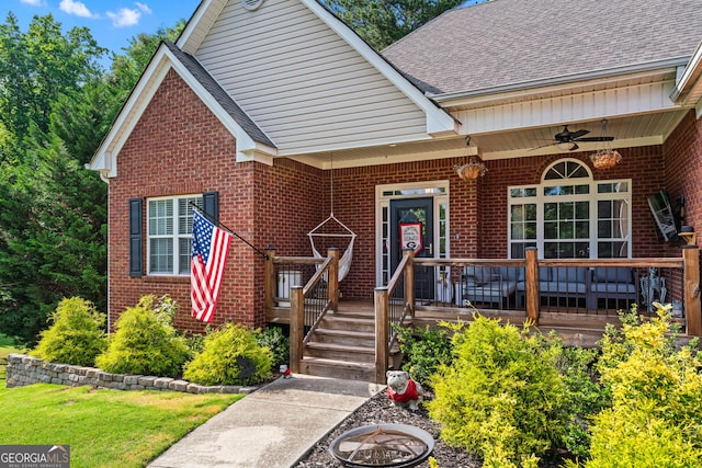 1436 Virginia Way, Monroe, GA 30655 - view of front of house featuring brick siding, ceiling fan, a shingled roof, a porch, and a front yard