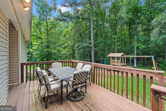 1436 Virginia Way, Monroe, GA 30655 - deck with outdoor dining space, a lawn, a playground, and a forest view