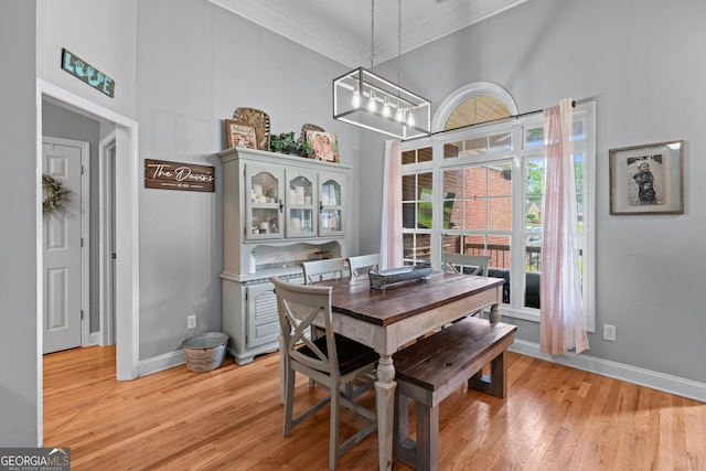 1436 Virginia Way, Monroe, GA 30655 - dining area with a high ceiling, crown molding, light wood-type flooring, and a chandelier