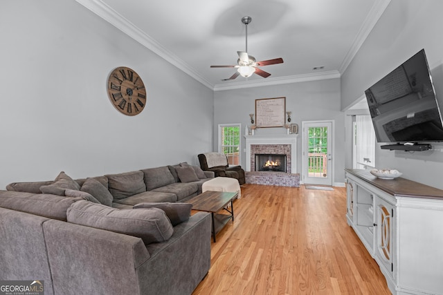 1436 Virginia Way, Monroe, GA 30655 - living room featuring ornamental molding, ceiling fan, light wood-style flooring, and a brick fireplace