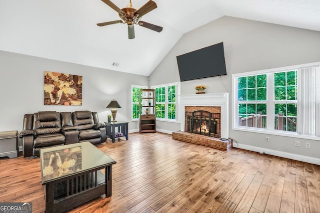 186 Ashley Dr, Mcdonough, GA 30252 - living area featuring ceiling fan, a brick fireplace, high vaulted ceiling, and wood finished floors