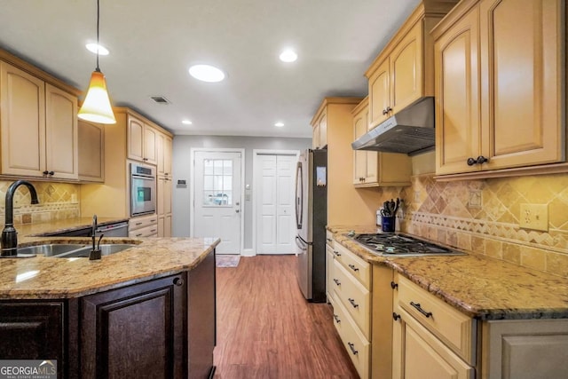 186 Ashley Dr, Mcdonough, GA 30252 - kitchen with under cabinet range hood, stainless steel appliances, wood finished floors, recessed lighting, and light stone counters