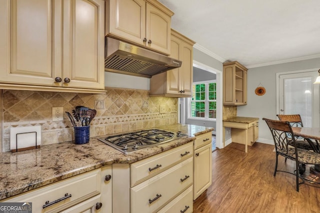 186 Ashley Dr, Mcdonough, GA 30252 - kitchen featuring stainless steel gas stovetop, under cabinet range hood, wood finished floors, tasteful backsplash, and light stone countertops