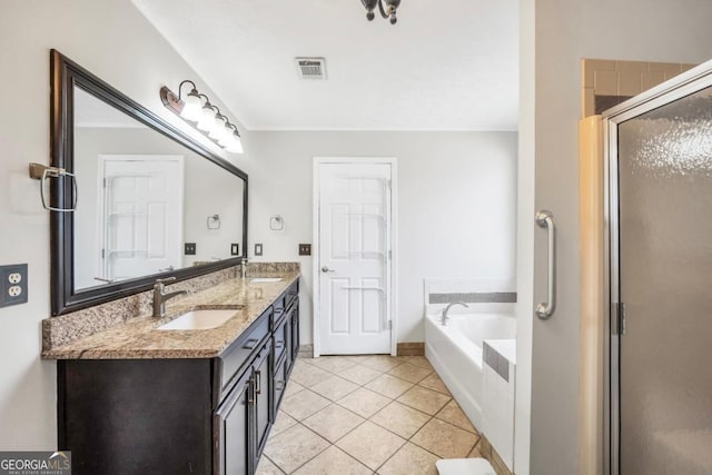 186 Ashley Dr, Mcdonough, GA 30252 - full bathroom featuring a garden tub, double vanity, tile patterned floors, and a stall shower