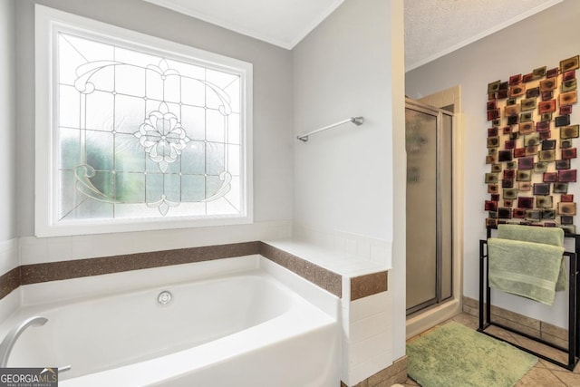 186 Ashley Dr, Mcdonough, GA 30252 - full bathroom featuring a bath, a stall shower, ornamental molding, and tile patterned floors