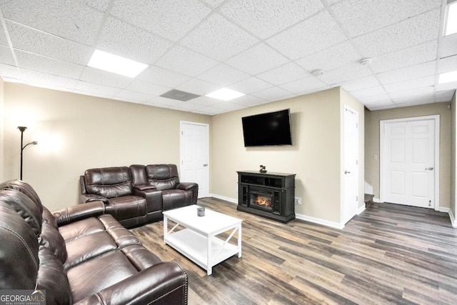 186 Ashley Dr, Mcdonough, GA 30252 - living room with wood finished floors, a paneled ceiling, and a fireplace