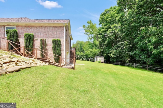 186 Ashley Dr, Mcdonough, GA 30252 - view of yard with a storage unit and stairs