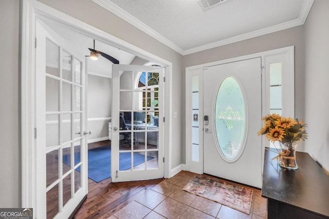 186 Ashley Dr, Mcdonough, GA 30252 - entryway with french doors, plenty of natural light, ornamental molding, ceiling fan, and tile patterned flooring