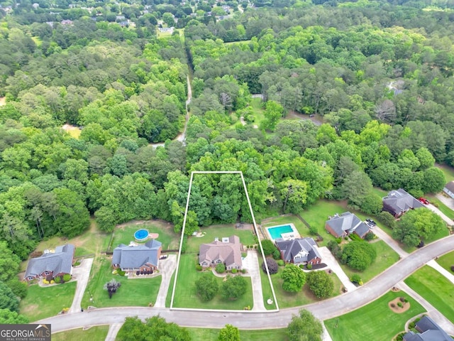 186 Ashley Dr, Mcdonough, GA 30252 - aerial view of property's location with a heavily wooded area and property parcel outlined