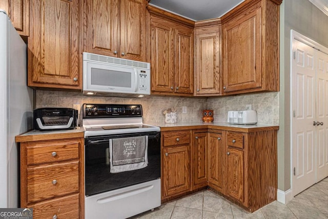 4110 Summit Chase, Gainesville, GA 30506 - kitchen featuring white microwave, electric range, and brown cabinets