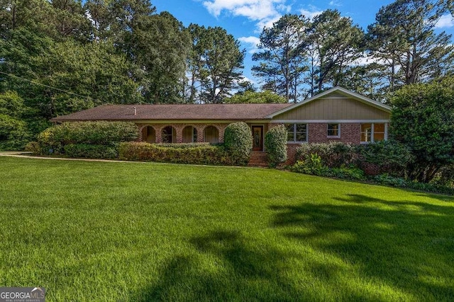 2585 Regency Dr E, Tucker, GA 30084 - ranch-style home featuring a front yard and brick siding