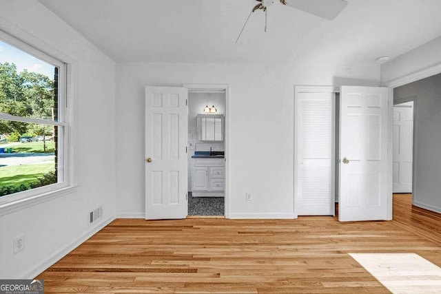 2585 Regency Dr E, Tucker, GA 30084 - unfurnished bedroom featuring connected bathroom and light wood-style floors