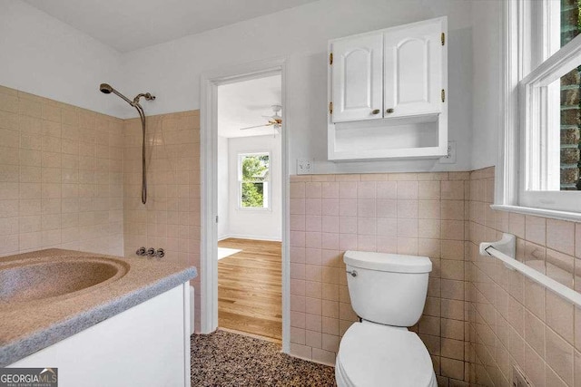 2585 Regency Dr E, Tucker, GA 30084 - full bathroom with tile walls, vanity, ceiling fan, and a wainscoted wall
