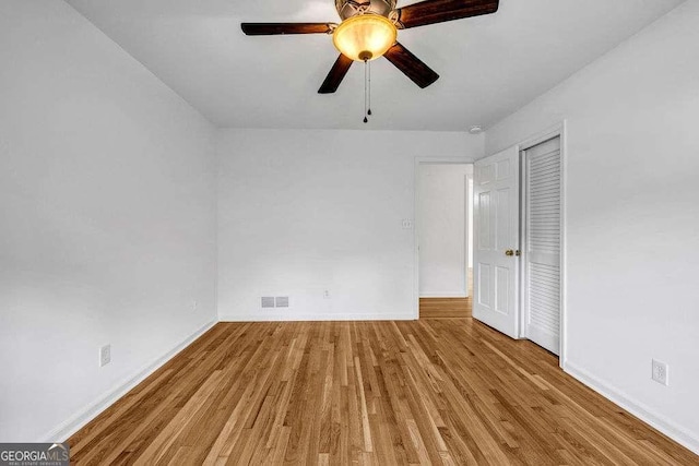 2585 Regency Dr E, Tucker, GA 30084 - unfurnished bedroom with wood finished floors, a closet, and a ceiling fan