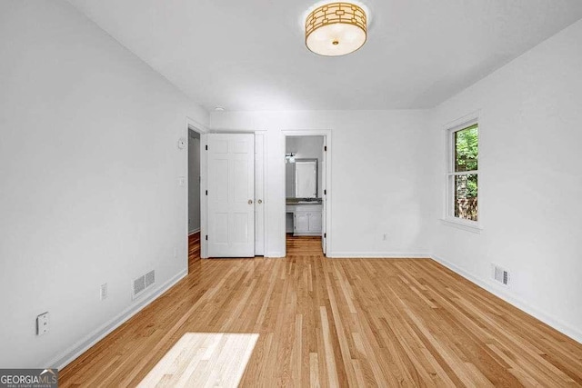 2585 Regency Dr E, Tucker, GA 30084 - unfurnished bedroom with light wood-style flooring and connected bathroom