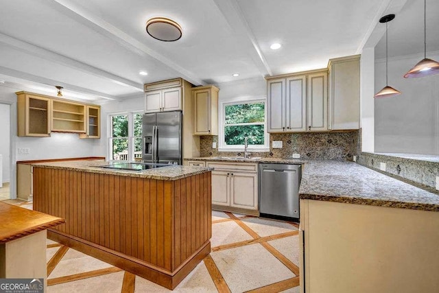 2585 Regency Dr E, Tucker, GA 30084 - kitchen featuring appliances with stainless steel finishes, inlaid floor details, backsplash, beam ceiling, and a kitchen island
