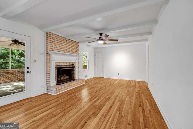 2585 Regency Dr E, Tucker, GA 30084 - unfurnished living room featuring a ceiling fan, beamed ceiling, light wood-style floors, and a fireplace