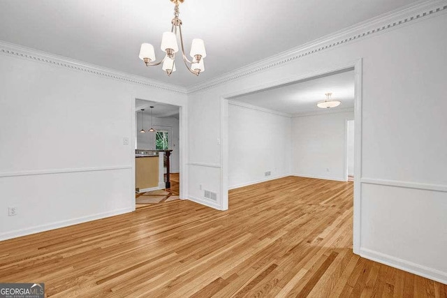 2585 Regency Dr E, Tucker, GA 30084 - empty room featuring a chandelier, wood finished floors, and ornamental molding