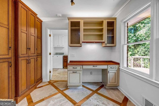 2585 Regency Dr E, Tucker, GA 30084 - unfurnished office with inlaid floor details, washer / dryer, built in desk, and plenty of natural light