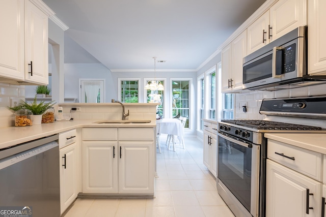 1805 Millstone Ct, Alpharetta, GA 30004 - kitchen with stainless steel appliances, tasteful backsplash, light countertops, white cabinetry, and crown molding