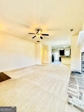113 Truman Ct, Jackson, GA 30233 - unfurnished living room with ceiling fan and a fireplace