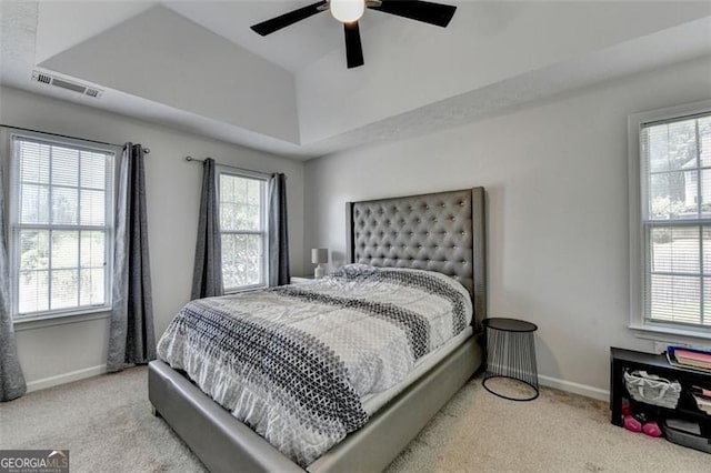 5385 Spotted Fawn Ct, Suwanee, GA 30024 - carpeted bedroom with multiple windows, a raised ceiling, and a ceiling fan