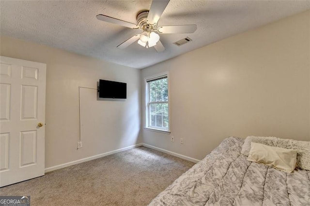 5385 Spotted Fawn Ct, Suwanee, GA 30024 - carpeted bedroom with a textured ceiling and a ceiling fan