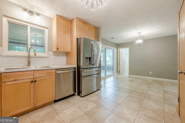 5868 Kingswood Ct NW, Norcross, GA 30093 - kitchen with stainless steel appliances, a chandelier, decorative backsplash, light brown cabinetry, and a textured ceiling