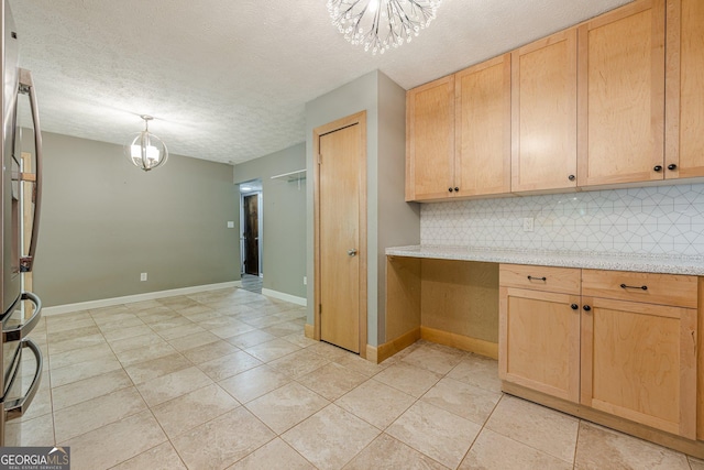 5868 Kingswood Ct NW, Norcross, GA 30093 - kitchen with a chandelier, tasteful backsplash, freestanding refrigerator, light brown cabinets, and a textured ceiling
