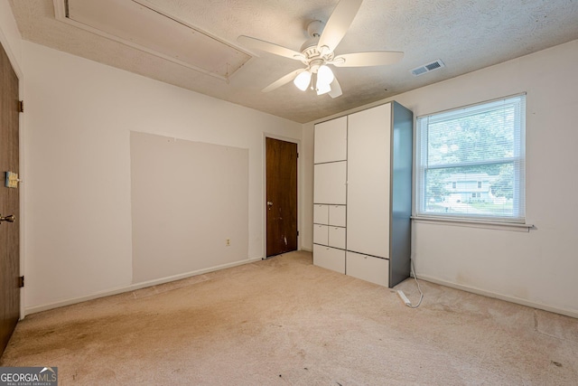 5868 Kingswood Ct NW, Norcross, GA 30093 - unfurnished bedroom with attic access, light carpet, a textured ceiling, and ceiling fan