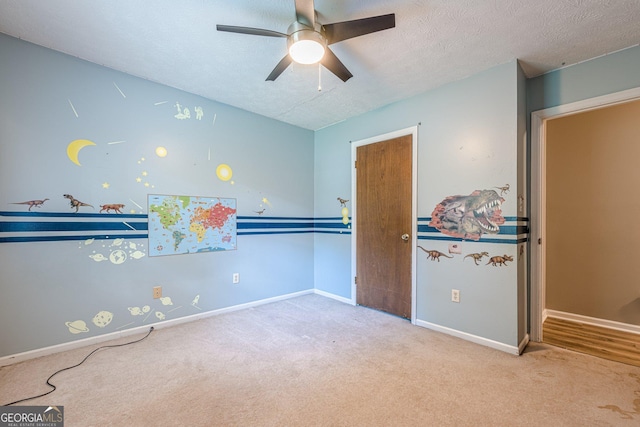 5868 Kingswood Ct NW, Norcross, GA 30093 - unfurnished bedroom with carpet floors, a textured ceiling, and a ceiling fan