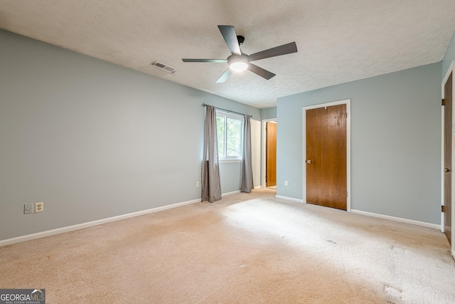 5868 Kingswood Ct NW, Norcross, GA 30093 - unfurnished bedroom featuring a textured ceiling, carpet, a ceiling fan, and a closet
