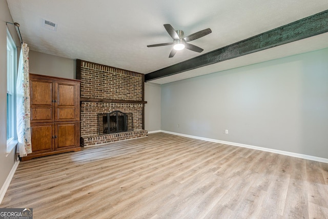 5868 Kingswood Ct NW, Norcross, GA 30093 - unfurnished living room with light wood-style flooring, a ceiling fan, a fireplace, and beamed ceiling