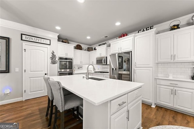 2213 Independence Ln, Buford, GA 30519 - kitchen with appliances with stainless steel finishes, white cabinets, backsplash, light countertops, and recessed lighting