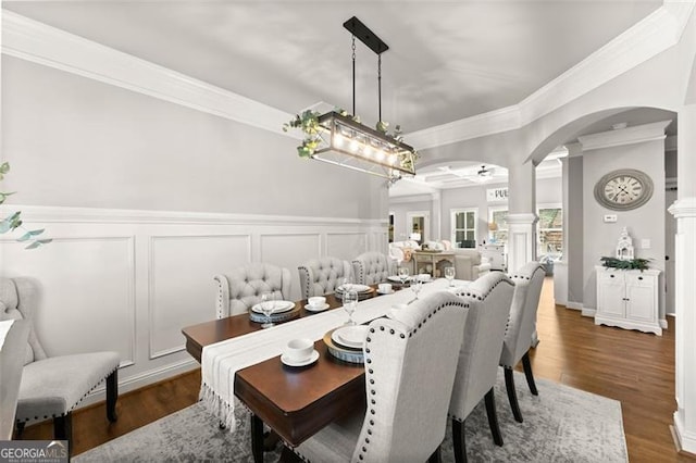 2213 Independence Ln, Buford, GA 30519 - dining space featuring ornamental molding, ornate columns, a decorative wall, arched walkways, and dark wood-style flooring