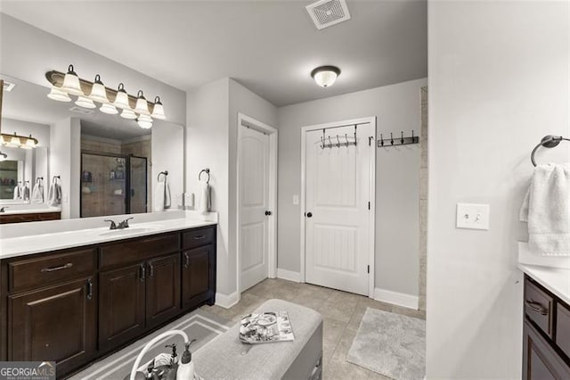 2213 Independence Ln, Buford, GA 30519 - bathroom with two vanities, a shower stall, and tile patterned flooring