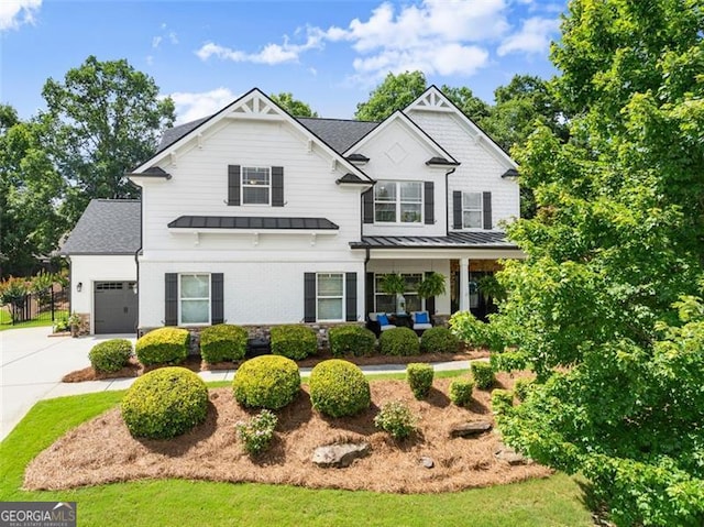 2213 Independence Ln, Buford, GA 30519 - view of front of property featuring a standing seam roof, an attached garage, concrete driveway, a metal roof, and roof with shingles
