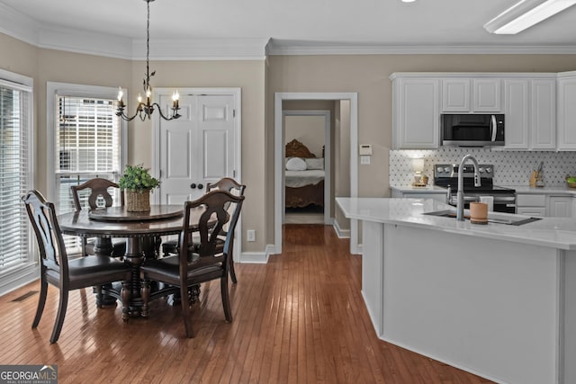 1120 Liberty Ln, Bogart, GA 30622 - dining area with a chandelier, wood-type flooring, and ornamental molding
