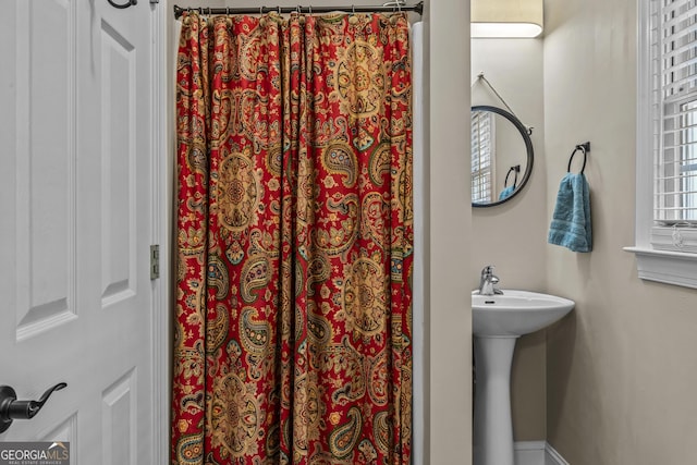 1120 Liberty Ln, Bogart, GA 30622 - bathroom with a shower with shower curtain and a sink
