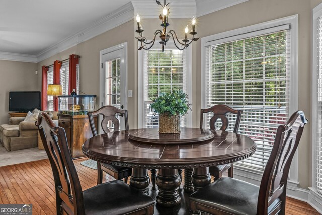 1120 Liberty Ln, Bogart, GA 30622 - dining space with a chandelier, crown molding, and hardwood / wood-style floors