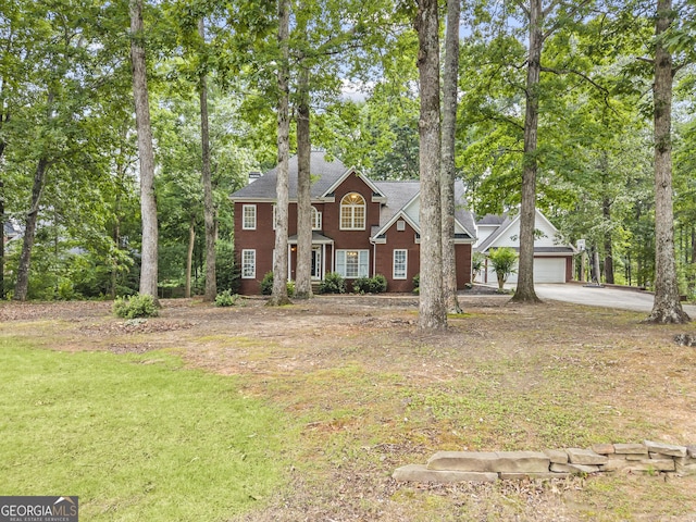 1120 Liberty Ln, Bogart, GA 30622 - colonial inspired home with driveway, a garage, a front lawn, and view of wooded area