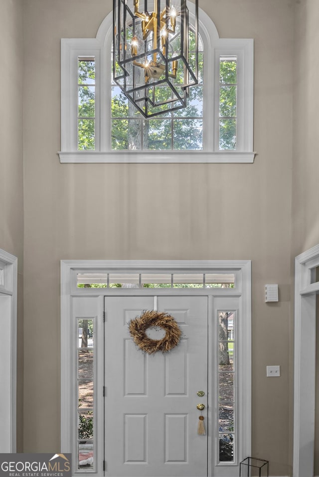 1120 Liberty Ln, Bogart, GA 30622 - foyer featuring a chandelier, a towering ceiling, and plenty of natural light