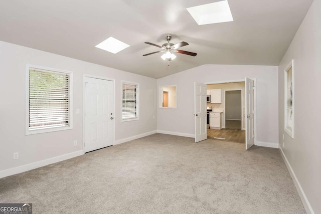 1024 Stone Mill Run, Lawrenceville, GA 30046 - unfurnished bedroom featuring a skylight, light colored carpet, a ceiling fan, and lofted ceiling