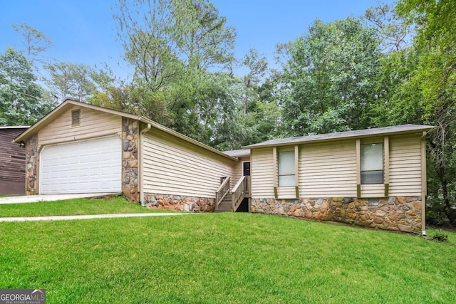 1024 Stone Mill Run, Lawrenceville, GA 30046 - view of front of house featuring a front yard, a garage, stone siding, and concrete driveway