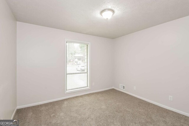 1024 Stone Mill Run, Lawrenceville, GA 30046 - empty room with carpet floors and a textured ceiling
