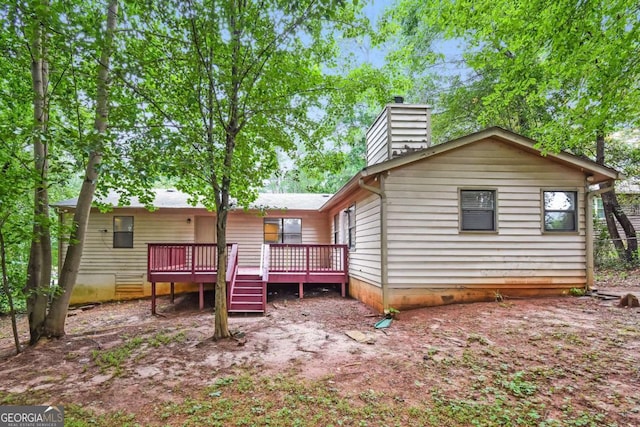 1024 Stone Mill Run, Lawrenceville, GA 30046 - back of property featuring a chimney and a deck