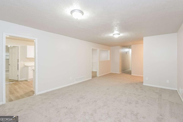 1024 Stone Mill Run, Lawrenceville, GA 30046 - carpeted empty room featuring baseboards and a textured ceiling