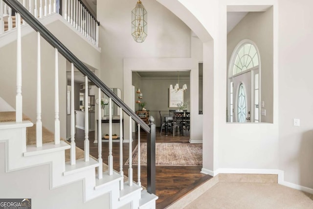 2000 Settindown Dr, Roswell, GA 30075 - foyer with a chandelier, stairway, a high ceiling, arched walkways, and wood finished floors