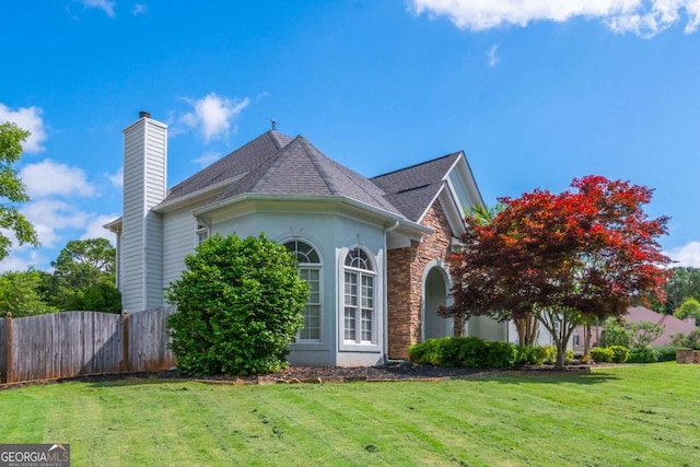 2000 Settindown Dr, Roswell, GA 30075 - view of side of home featuring stone siding, a chimney, roof with shingles, and stucco siding
